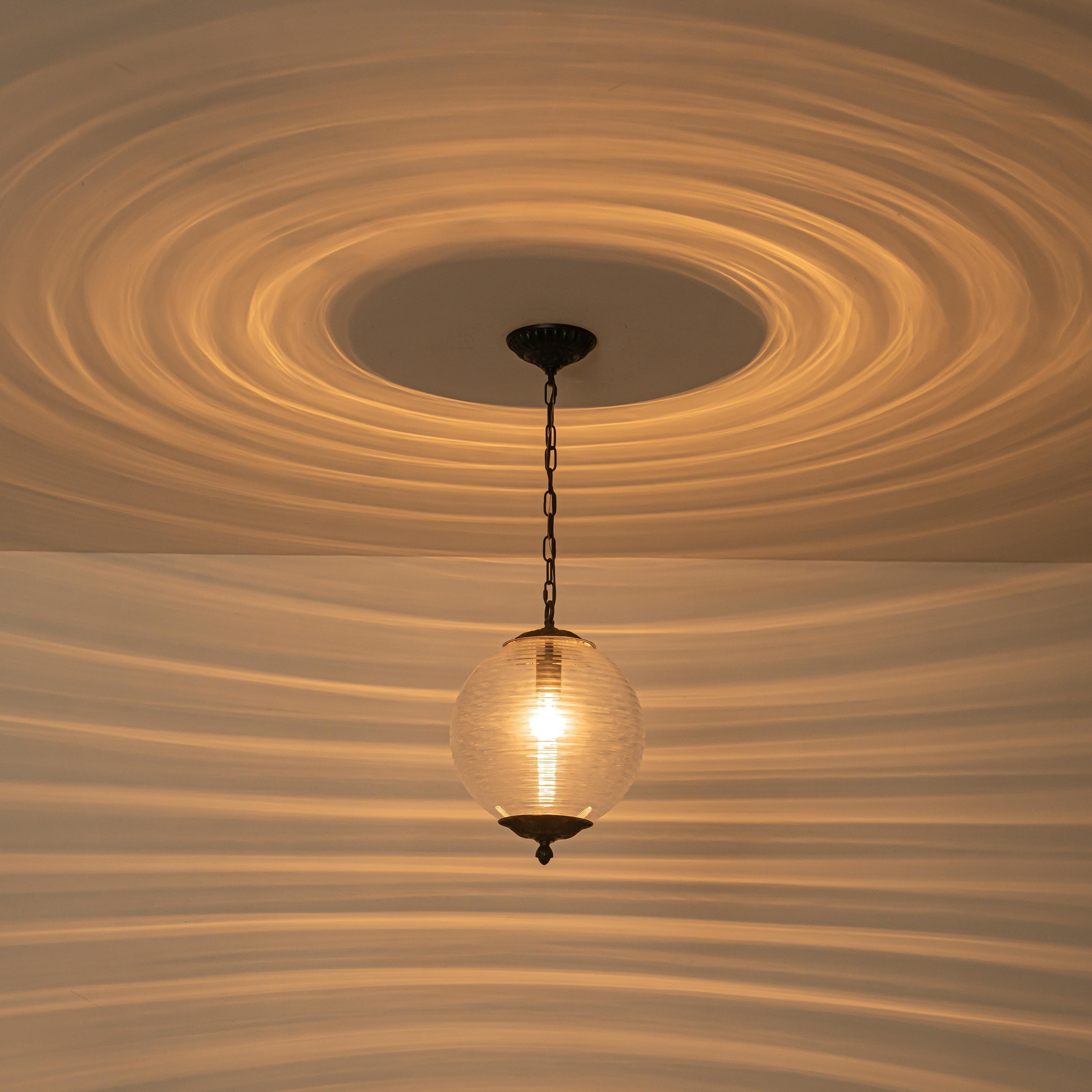 Glowlings 1-Light Classic Aged Brass/Black Clear Swirl Glass Globe Pendant Light