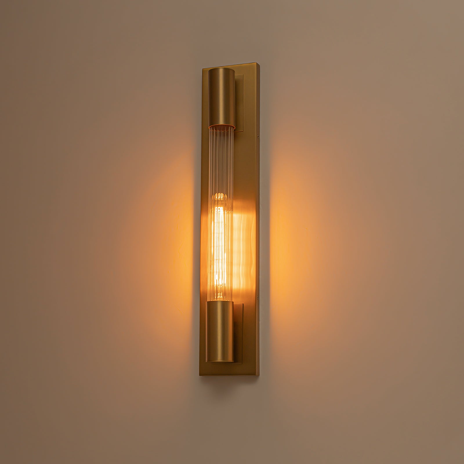 Glowlings 1-Light Modern Brushed Brass Cylinder Ribbed Clear Glass Tube Wall Sconce