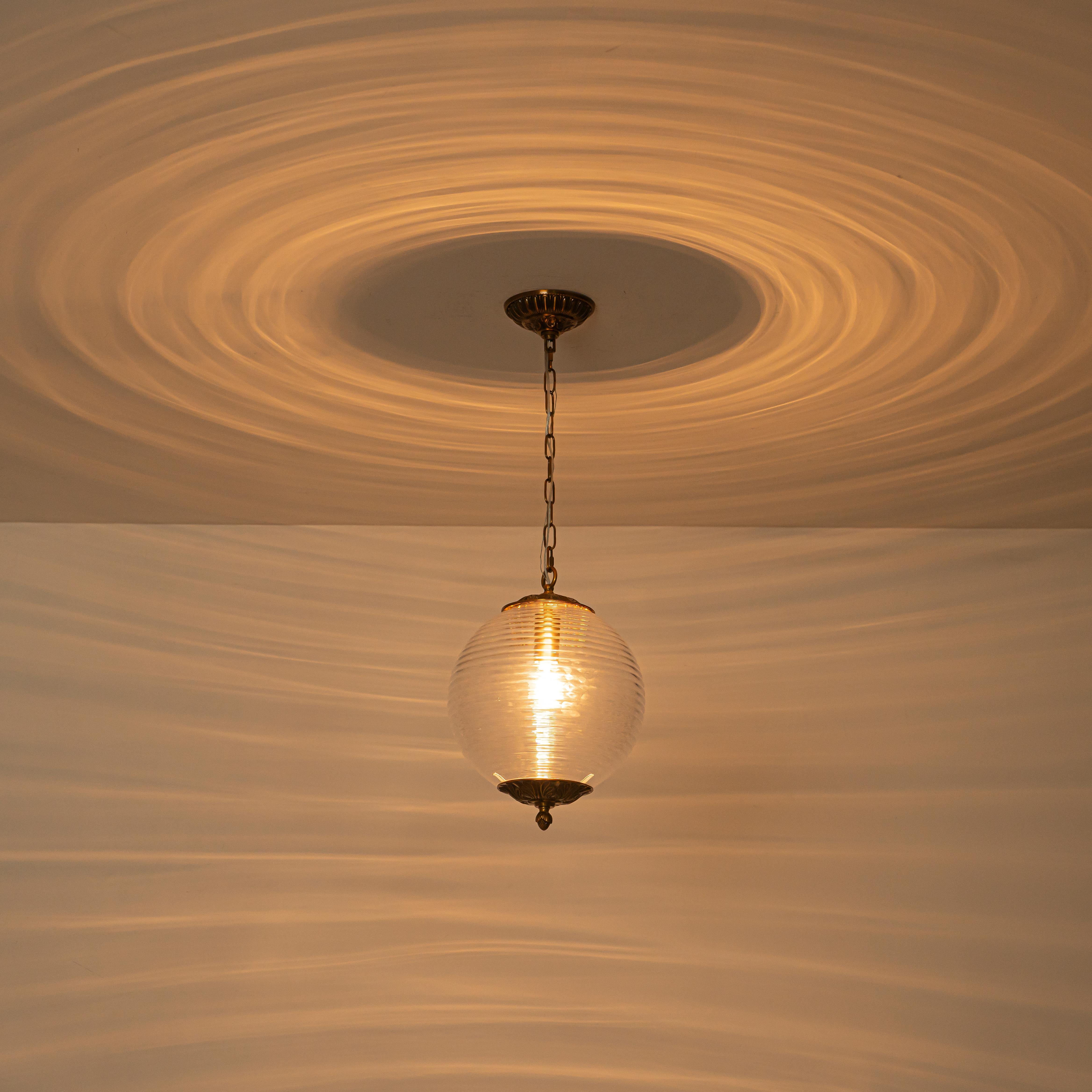Glowlings 1-Light Classic Aged Brass/Black Clear Swirl Glass Globe Pendant Light